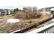 View of the home's fenced backyard and treed common area as seen from a second story deck at 295 Kitselman Dr, Castle Rock, CO 80104