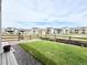View of the home's fenced backyard with lawn area surrounded by wood fencing and small rocks at 295 Kitselman Dr, Castle Rock, CO 80104