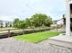 Landscaped backyard featuring a wooden fence, manicured lawn, decorative rocks, and lovely green trees at 295 Kitselman Dr, Castle Rock, CO 80104