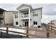 Exterior view of the home with a backyard patio, fencing, and a two-story porch at 295 Kitselman Dr, Castle Rock, CO 80104