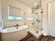 This bathroom features a freestanding tub, glass enclosed shower, and modern fixtures at 295 Kitselman Dr, Castle Rock, CO 80104