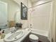 Bright bathroom featuring a tub and shower combination with white tile surround, plus a granite countertop vanity at 295 Kitselman Dr, Castle Rock, CO 80104