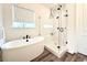 Bright bathroom with a sleek soaking tub, a glass-enclosed shower, and modern fixtures at 295 Kitselman Dr, Castle Rock, CO 80104