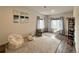 Relaxing bedroom space featuring plush seating, neutral carpeting, and large windows providing abundant natural light at 295 Kitselman Dr, Castle Rock, CO 80104