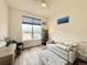 Cozy bedroom featuring a window, ceiling fan, sofa, and desk with neutral decor at 295 Kitselman Dr, Castle Rock, CO 80104