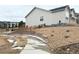 Side view of a home with a well-maintained landscape, a retaining wall, and a stone walkway at 295 Kitselman Dr, Castle Rock, CO 80104