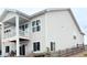 Exterior view of a two-story home featuring a covered deck, sliding glass doors, and a fenced backyard at 295 Kitselman Dr, Castle Rock, CO 80104