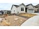 Charming home with a two-car garage, sidewalk, and low maintenance xeriscape at 295 Kitselman Dr, Castle Rock, CO 80104