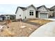 This home features a 2 car garage, siding, and well-maintained landscaping at 295 Kitselman Dr, Castle Rock, CO 80104