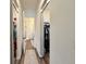 Hallway that opens to several closets, with rugs accenting the wood floors at 295 Kitselman Dr, Castle Rock, CO 80104