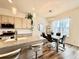 Well-lit kitchen featuring a granite countertop island, stainless appliances, and a dining area at 295 Kitselman Dr, Castle Rock, CO 80104