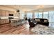 The living room and kitchen features natural light, an island, and hardwood floors at 295 Kitselman Dr, Castle Rock, CO 80104