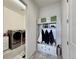 Organized mudroom entry with storage bench, shelving, and adjacent laundry area for convenience at 295 Kitselman Dr, Castle Rock, CO 80104