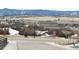 View of the neighborhood from the corner of an intersection, showing hills in the distance at 295 Kitselman Dr, Castle Rock, CO 80104