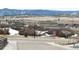 Neighborhood street view with new homes, scrubby fields, and snow-capped mountains in the background at 295 Kitselman Dr, Castle Rock, CO 80104