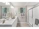 Elegant bathroom with double vanity and a walk-in shower at 4410 Cattle Cross Rd, Castle Rock, CO 80104