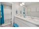 Bathroom with double vanity, tub and shower, and teal accents at 4410 Cattle Cross Rd, Castle Rock, CO 80104