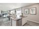 Modern kitchen with island, stainless steel appliances, and white cabinets at 4410 Cattle Cross Rd, Castle Rock, CO 80104