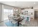 Modern kitchen with white cabinets, stainless steel appliances, and an island at 4410 Cattle Cross Rd, Castle Rock, CO 80104