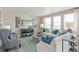 Living room with gray armchairs, white sofa, and teal pillows at 4410 Cattle Cross Rd, Castle Rock, CO 80104