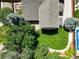 Aerial shot of a landscaped backyard, showing a large grass area and stone patio at 14910 Williams St, Thornton, CO 80602