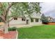 Exterior view of a two-story home with a well-maintained lawn, mature trees, and outdoor space at 14910 Williams St, Thornton, CO 80602
