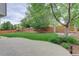 Manicured lawn surrounded by stone patio, lush greenery, and wooden fencing at 14910 Williams St, Thornton, CO 80602