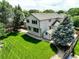 Aerial view of backyard featuring a spacious lawn, patio, and mature trees at 14910 Williams St, Thornton, CO 80602