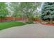 Beautiful backyard featuring a stone patio, lush lawn and landscaping, great for outdoor entertaining at 14910 Williams St, Thornton, CO 80602