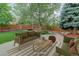 Staged backyard patio with cozy seating, a fire pit, and lush greenery, perfect for entertaining at 14910 Williams St, Thornton, CO 80602