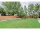 Expansive backyard with lush lawn, wooden fence, and mature trees at 14910 Williams St, Thornton, CO 80602