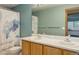 Bright bathroom featuring double sinks, spacious vanity, shower, and towel rack at 14910 Williams St, Thornton, CO 80602