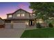 Charming two-story home with a well-manicured lawn and brick accents, enhanced by a lovely dusk sky at 14910 Williams St, Thornton, CO 80602