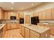 Well-appointed kitchen featuring granite countertops, wooden cabinetry, and modern appliances at 14910 Williams St, Thornton, CO 80602