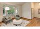 Bright and airy living room highlighting a bay window, plush seating, and chic decor at 14910 Williams St, Thornton, CO 80602