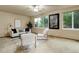 Bright living room with neutral carpet and decor, featuring large windows for natural light at 14910 Williams St, Thornton, CO 80602