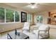 Cozy living room with slider door access to backyard, neutral paint, and ceiling fan at 14910 Williams St, Thornton, CO 80602