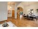 Open-concept living space with hardwood floors and a staircase leading to upper floors at 14910 Williams St, Thornton, CO 80602
