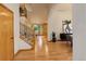 Spacious entry area showcasing a staircase and seamless flow into the dining and kitchen areas at 14910 Williams St, Thornton, CO 80602