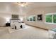 Spacious main bedroom featuring two windows, neutral carpet, and modern decor at 14910 Williams St, Thornton, CO 80602