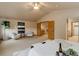 Spacious main bedroom boasting a ceiling fan, sitting area, and an ensuite bathroom for added comfort at 14910 Williams St, Thornton, CO 80602