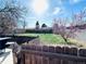 Spacious backyard with a mix of grass and pea gravel, enclosed by a wooden fence at 413 Jamaica St, Aurora, CO 80010