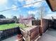Lush backyard featuring a well-maintained lawn, charming fence, and tree with vibrant blossoms at 413 Jamaica St, Aurora, CO 80010