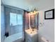 Bathroom features a tub with tile surround, vanity with sink, and modern fixtures at 413 Jamaica St, Aurora, CO 80010