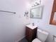 Bathroom features a tile floor, modern fixtures, and vanity with sink at 413 Jamaica St, Aurora, CO 80010