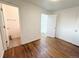 Bedroom featuring a hardwood floor and entrance to the bathroom and closet at 413 Jamaica St, Aurora, CO 80010