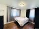 Bright bedroom with wood flooring, features ample natural light and neutral decor at 413 Jamaica St, Aurora, CO 80010