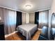 Cozy bedroom featuring modern curtains, wood floors, and a comfortable double bed at 413 Jamaica St, Aurora, CO 80010