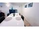 Bright dining room with a white table, black chairs, and simple decor in a well-lit space at 413 Jamaica St, Aurora, CO 80010