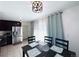 Bright dining room with table, chairs, stainless steel refrigerator and tile floor at 413 Jamaica St, Aurora, CO 80010